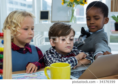 Business people discussing over laptop in office Business people discussing over laptop in office 34376399