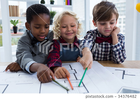 Business people analyzing blueprint at table in office 34376482