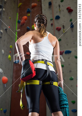 Woman standing with hands on hip in fitness studio Woman standing with hands on hip in fitness studio 34376543