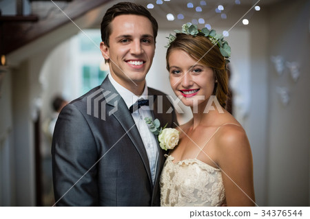 Wedding couple standing together in hall 34376544