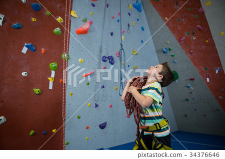 Boy standing with rope in fitness studio 34376646