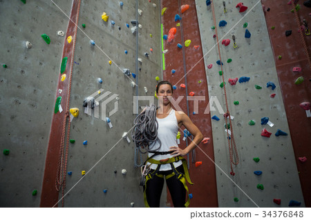 Woman standing with hands on hip in fitness studio 34376848