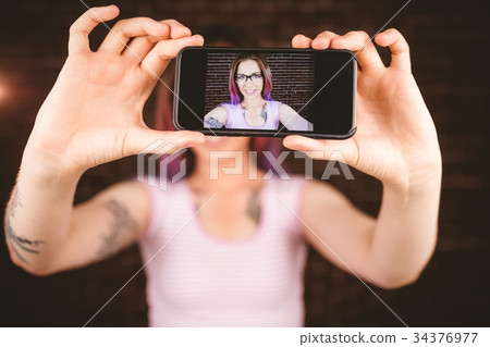 Smiling woman taking selfie from mobile phone 34376977