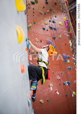Determined boy practicing rock climbing Determined boy practicing rock climbing 34376986