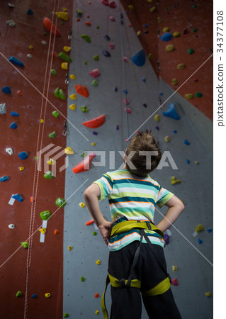 Thoughtful boy looking at wall in fitness studio Thoughtful boy looking at wall in fitness studio 34377108