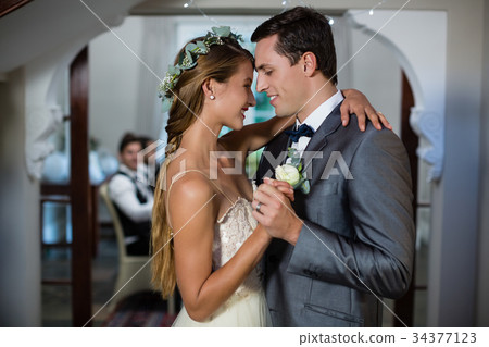 Wedding couple dancing in hall 34377123