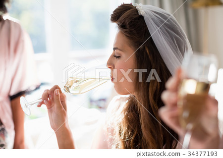 Women drinking a glasses of champagne 34377193