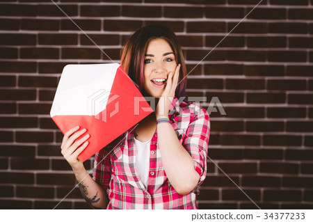 Surprise woman holding envelope 34377233