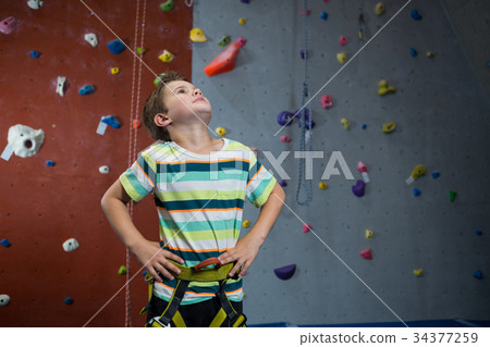 Boy standing with hands on hip in fitness studio 34377259