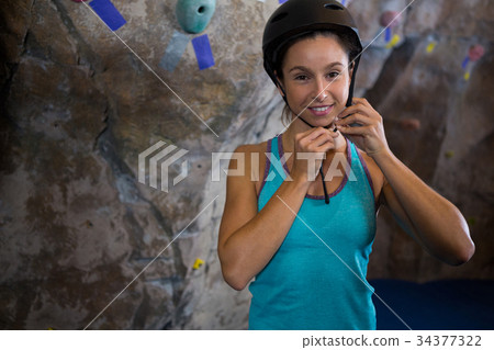 Woman wearing protective helmet in fitness studio 34377322