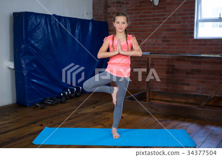 Portrait of teenage girl practicing yoga Portrait of teenage girl practicing yoga 34377504