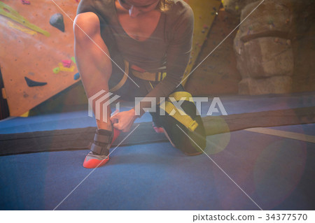 Determined woman wearing sport shoes Determined woman wearing sport shoes 34377570
