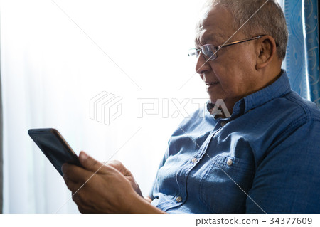 Senior man using tablet at nursing home Senior man using tablet at nursing home 34377609