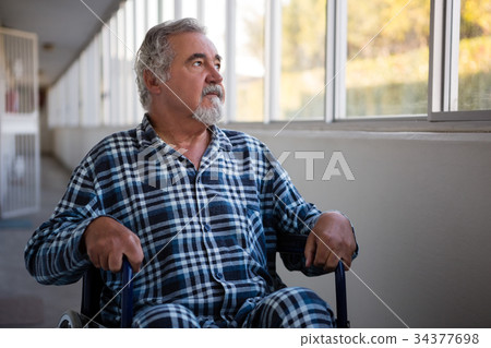 Thoughtful senior man sitting on wheelchair in nursing home 34377698
