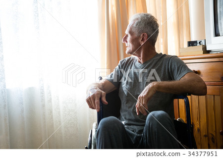 Thoughtful senior man sitting on wheelchair in nursing home 34377951