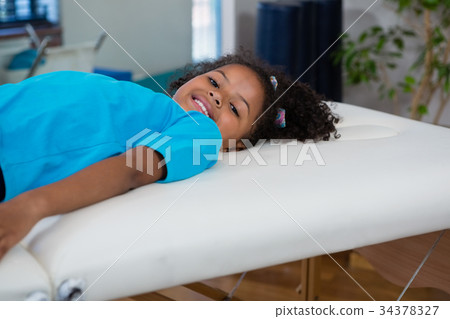 Portrait of girl lying on bed Portrait of girl lying on bed 34378327