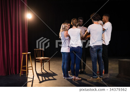 Actors team forming their hands stacked 34379362