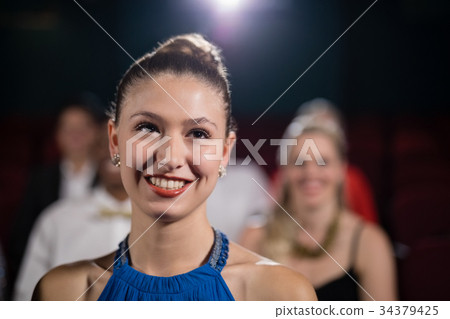 Woman sitting in movie theatre 34379425