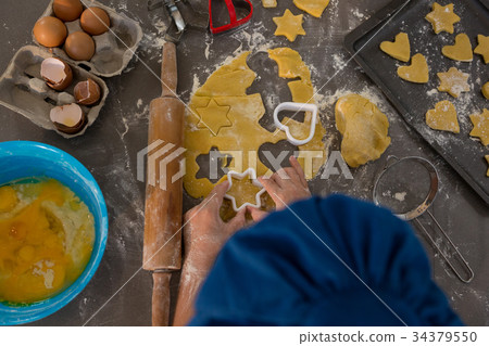 Cropped image of boy preparing cookies 34379550