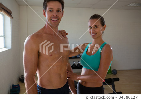 Portrait of athletes standing in fitness studio Portrait of athletes standing in fitness studio 34380127