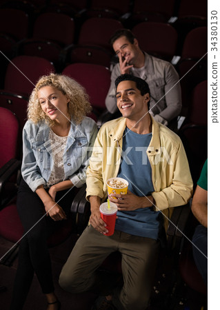 Couple watching movie in theatre Couple watching movie in theatre 34380130