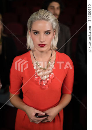 Woman standing in movie theatre 34380450