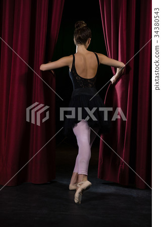 Ballerina performing ballet dance on stage 34380543