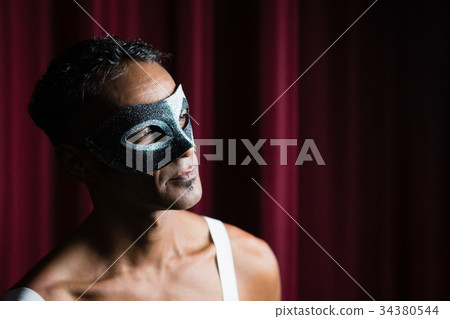 Man wearing masquerade mask 34380544