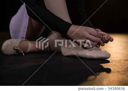 Ballerina tying her shoes 34380636