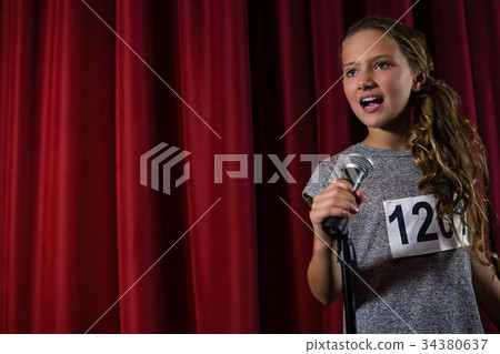 Female artist singing song on stage 34380637