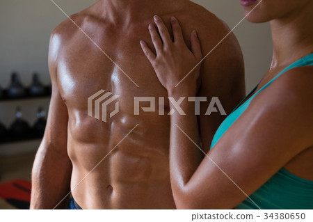 Midsection of athletes in fitness club Midsection of athletes in fitness club 34380650
