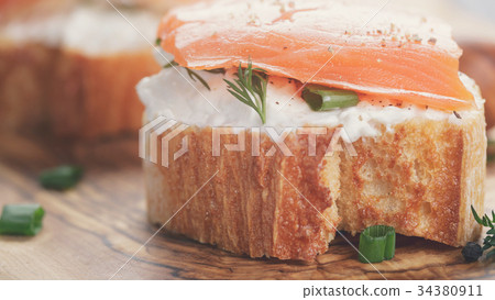 small sandwiches with soft cheese and salmon 34380911
