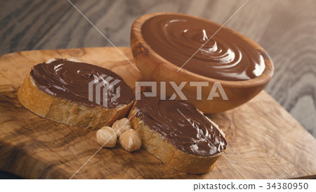 two baguette slices with chocolate hazelnut spread two baguette slices with chocolate hazelnut spread 34380950