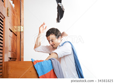 man throwing clothes in air 34381825