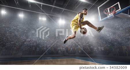 Basketball player makes slam dunk 34382009