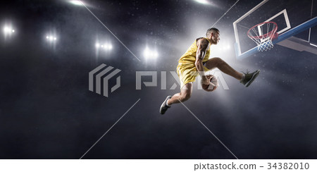 Basketball player makes slam dunk 34382010