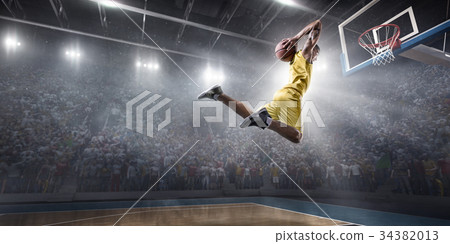 Basketball player makes slam dunk 34382013