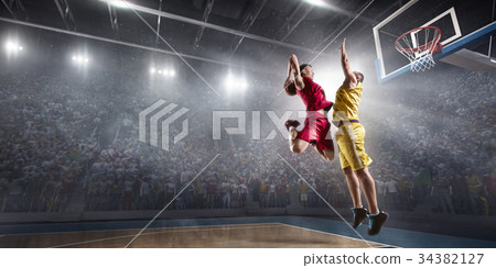 Basketball player makes slam dunk Basketball player makes slam dunk 34382127