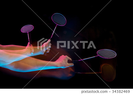 The hands of young man playing badminton over The hands of young man playing badminton over 34382469