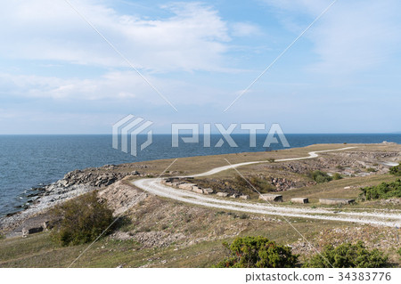 Landscape witha gravel road along the coast 34383776