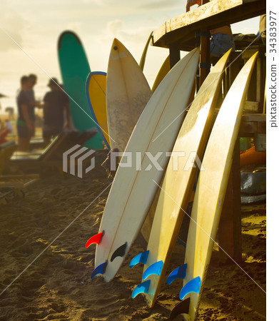 Beach surfers rental surfboards sunset 34383977