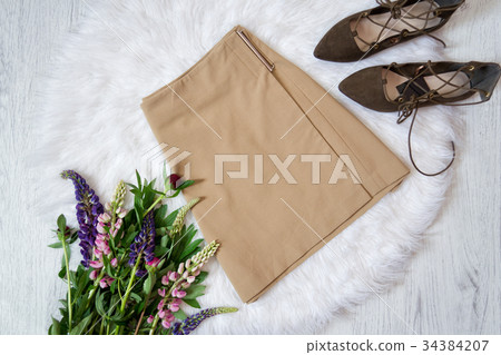 Light brown suede skirt and shoes on white fur 34384207