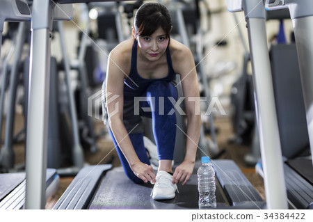 Female athlete preparing to run Female athlete preparing to run 34384422