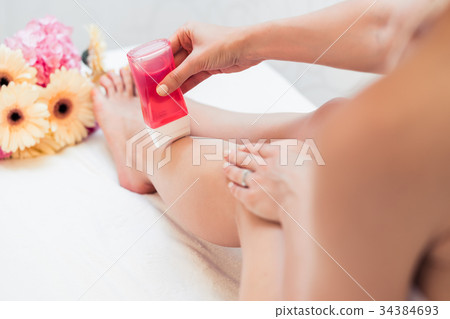 Hand of a young woman using a modern recharchable 34384693