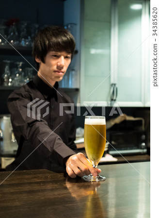 Bartender offering beer 34385620