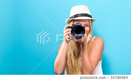 Young woman comparing professional camera 34386964