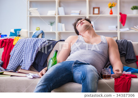 Young man student drunk drinking alcohol in a Young man student drunk drinking alcohol in a 34387306