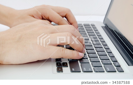 Hand is on the computer keyboard. Hand is on the computer keyboard. 34387588