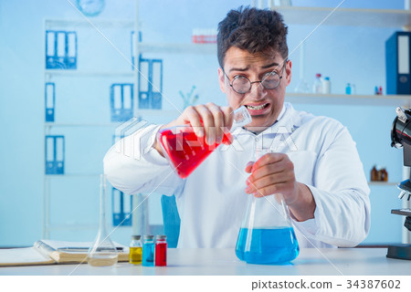 Funny mad chemist working in a laboratory 34387602