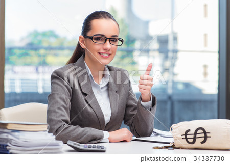 Businesswoman with money sack bag in office Businesswoman with money sack bag in office 34387730